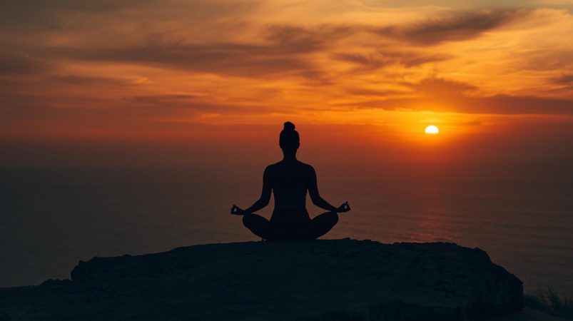 Blog - woman sitting on a rock sunset